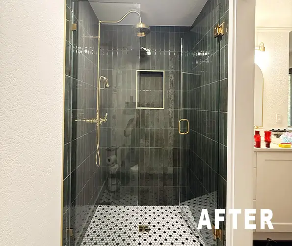 Bathroom after remodel with dark green tile shower and patterned floor
