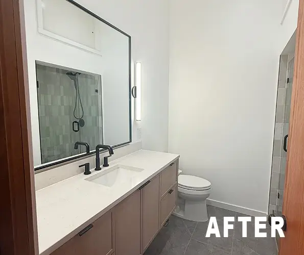 Bathroom after remodel with long double vanity and full-width mirror