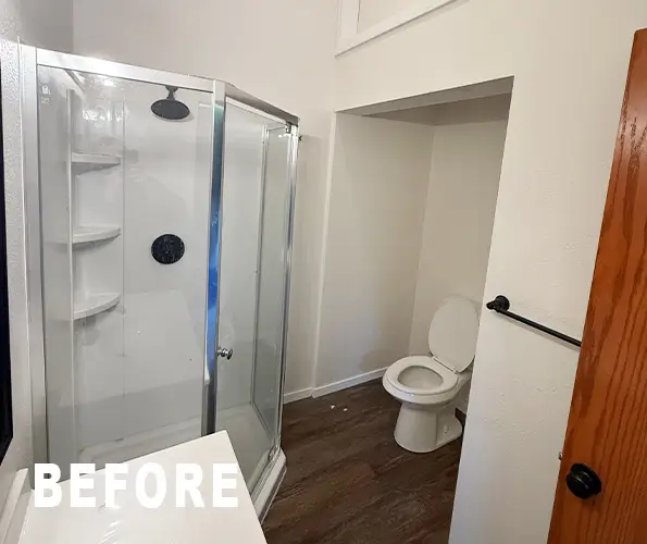 Bathroom before remodel with corner fiberglass shower stall
