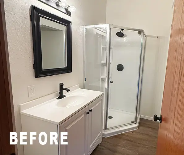 Bathroom before remodel with single vanity and corner shower unit